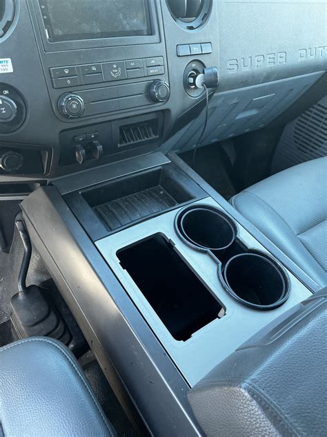 This console features dual cup holders with a small storage area in the middle. . Aftermarket center console ford expedition